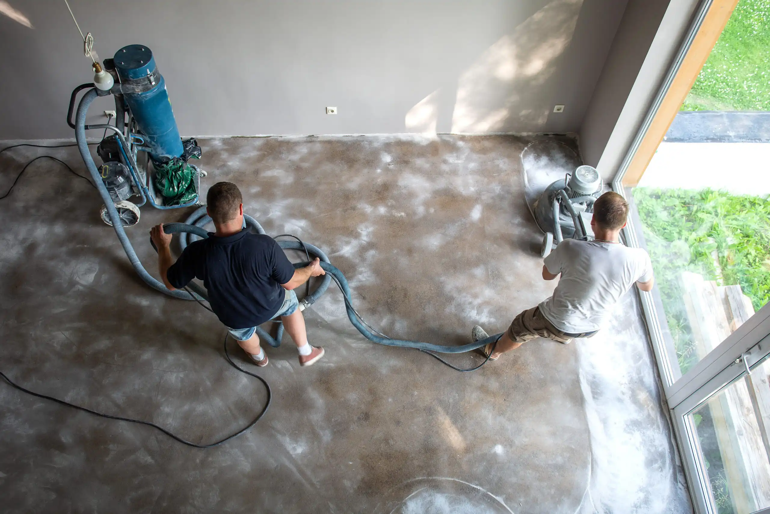house-restoration-work-a-two-workers-grinds-concr